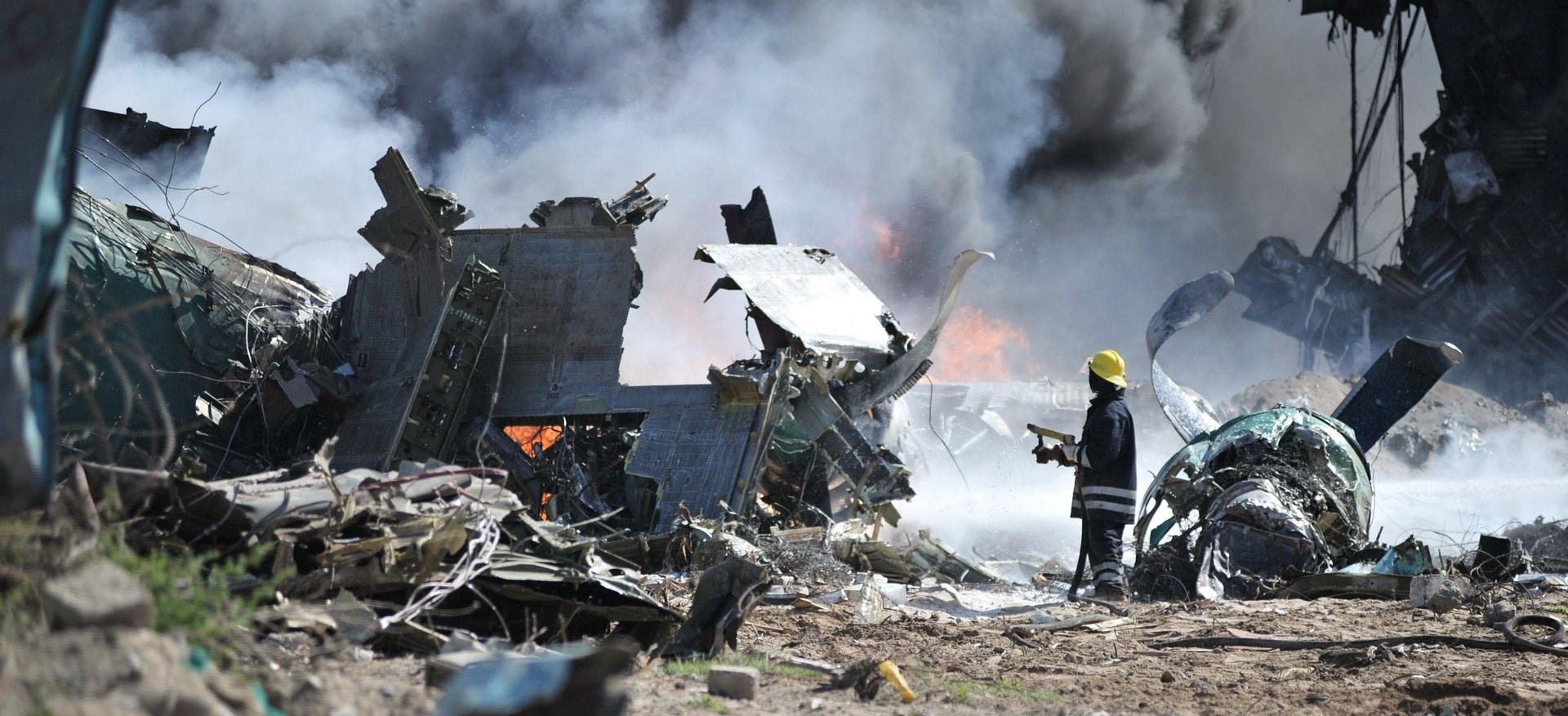 fireman looking at a burnt building