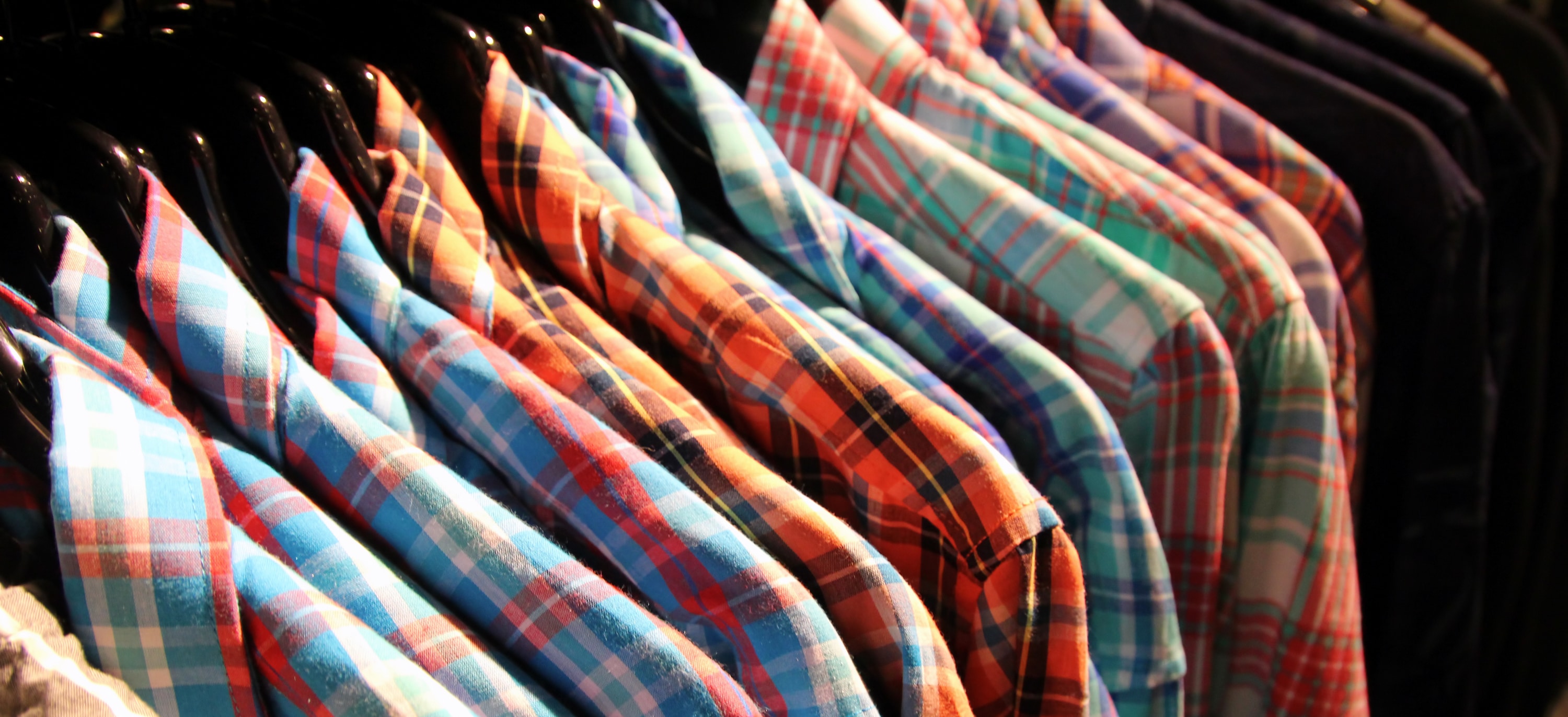 plaid shirts hung on a rack